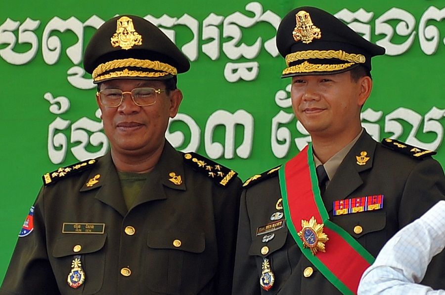 On 13 October 2009, Cambodia's then prime minister Hun Sen (left) poses with his son Hun Manet during a ceremony at a military base in Phnom Penh, Cambodia. (Tang Chhin Sothy/AFP)