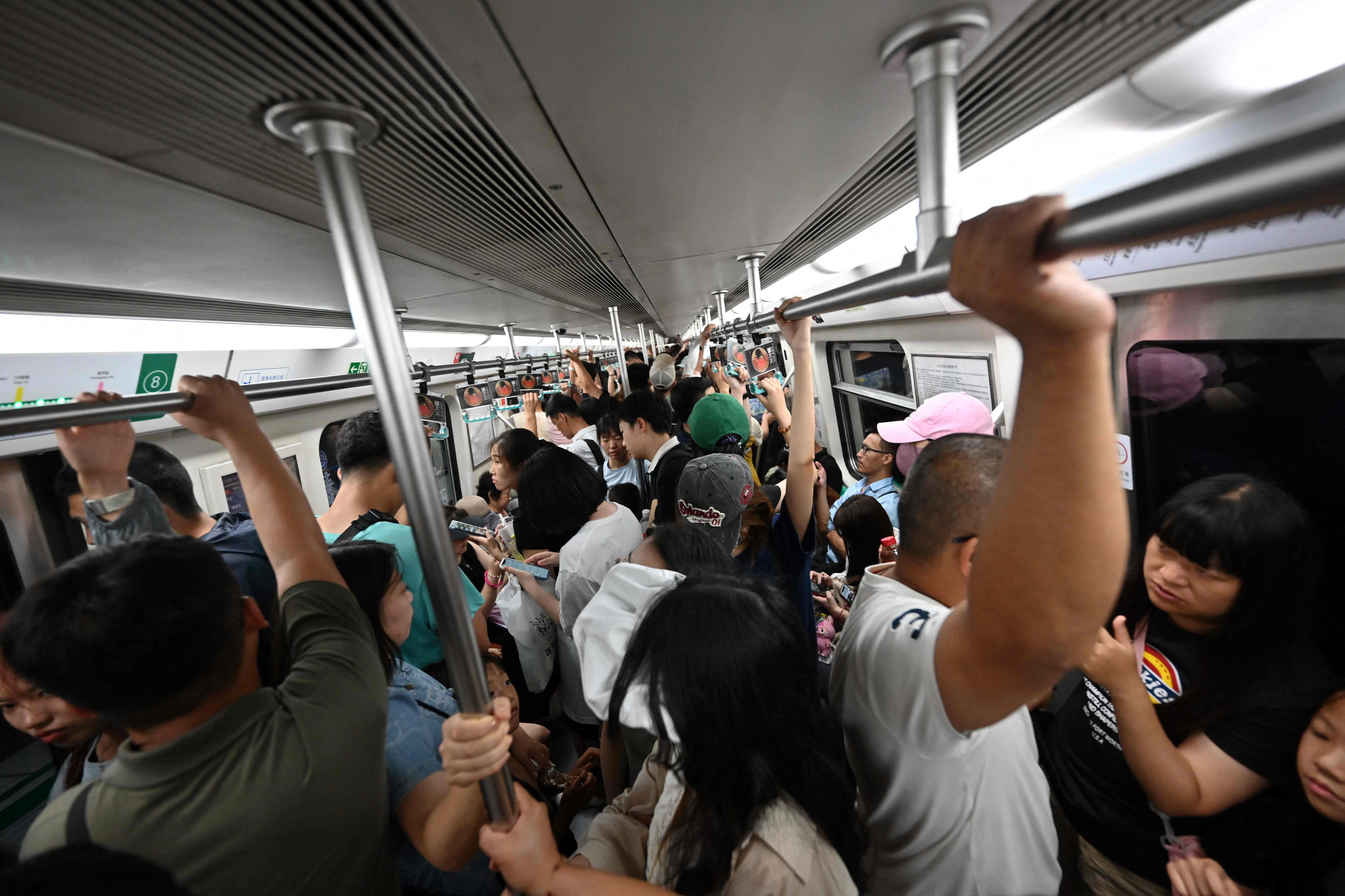 People travel on a subway in Beijing, China, on 2 August 2024. (Adek Berry/AFP)