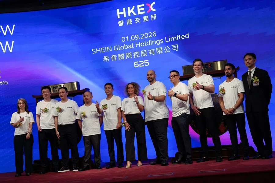 Founder and chairman of online retailer Shein, Xu Yangtian, poses for photos with staff members at the company's listing ceremony at the Hong Kong Stock Exchange in Hong Kong, China, 1 September 2026.