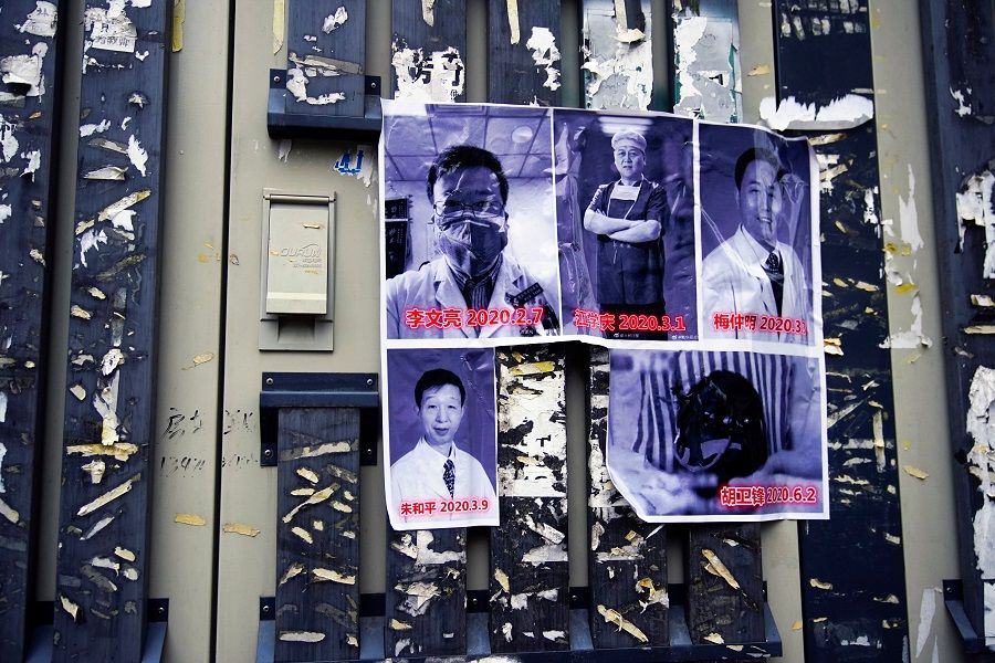 Posters in memory of late doctor Li Wenliang and other doctors are seen on a street near the Central Hospital of Wuhan, in Wuhan, Hubei province, China, 7 February 2021. (Aly Song/Reuters)