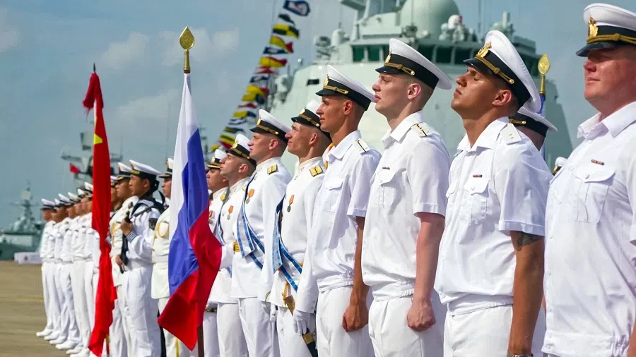 A grab taken from a handout footage released by the Russian Defence Ministry on 15 July 2024 shows Russian and Chinese sailors taking part in the opening ceremony of a joint maritime exercises at a port in Zhanjiang in China’s southern Guangdong province.