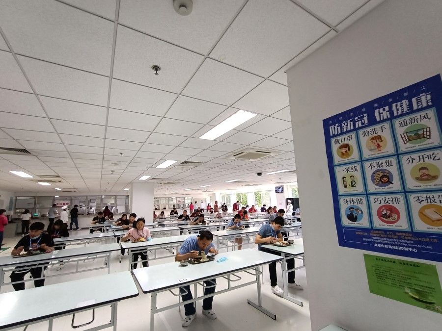Workers at Renesas (China) having a meal in the staff canteen.