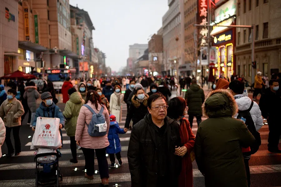 People walk along Wangfujing shopping street in Beijing, China, on 14 February 2021. (Noel Celis/AFP)