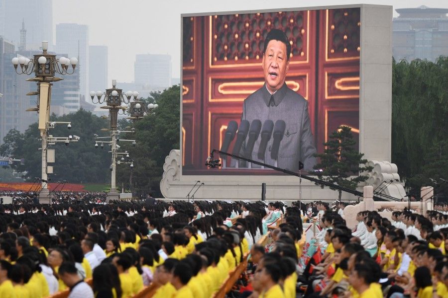 In this file photo taken on 1 July 2021, a large screen displays China's President Xi Jinping delivering a speech during the celebrations of the 100th anniversary of the founding of the Communist Party of China at Tiananmen Square in Beijing. (Wang Zhao / AFP)