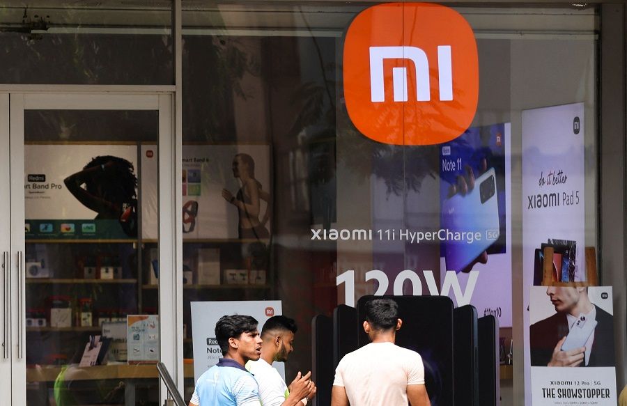 People walk past a Xiaomi store in Mumbai, India, 11 May 2022. (Francis Mascarenhas/Reuters)