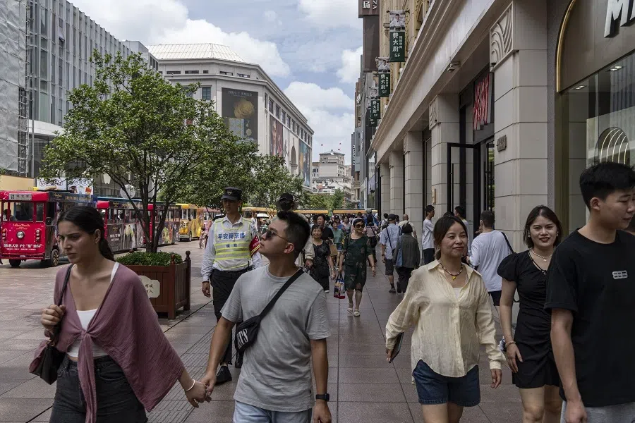 Pedestrians walk down Nanjing Road in Shanghai, China, on 27 July 2024. 