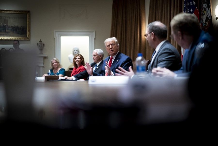 US President Donald Trump, center, speaks during a meeting in the Cabinet Room of the White House in Washington, 3 August 2020. Trump said ByteDance Ltd.'s TikTok will have to close in the US by 15 September, unless there's a deal to sell the social network's domestic operations to Microsoft Corp. or another US company. (Doug Mills/Bloomberg)