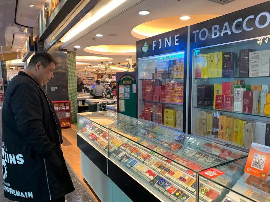 A man looks at cigarettes for sale.