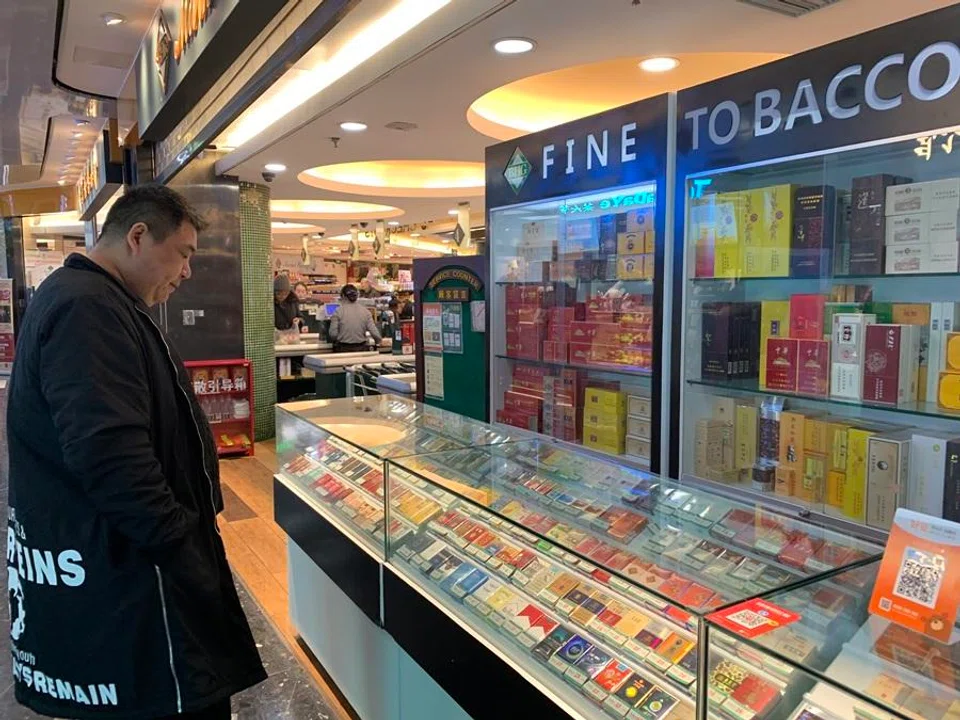 A man looks at cigarettes for sale. (SPH Media)