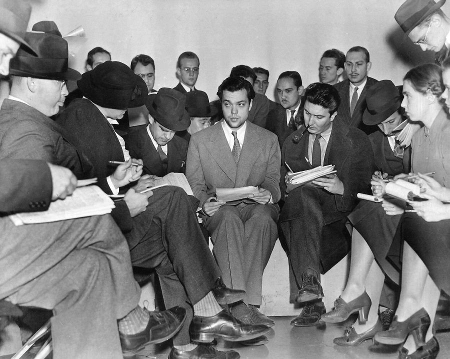 Photo of Orson Welles (centre) meeting with reporters after "The War of the Worlds" radio broadcast. Welles tried to explain that he and his theatre company had no idea the broadcast would cause panic. (Wikimedia)