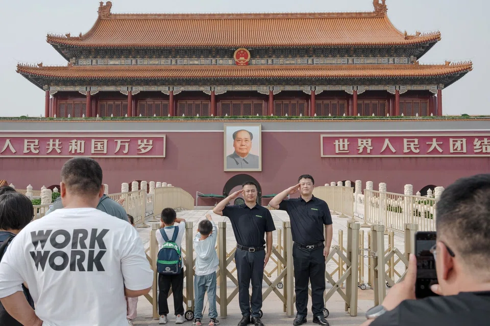 Visitors salute in front of a portrait of former Chinese leader Mao Zedong at Tiananmen Square in Beijing, China, on 10 July 2024. (Na Bien/Bloomberg)
