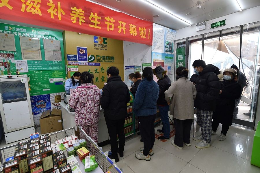 Residents line up at a pharmacy to buy antigen testing kits for Covid-19, in Nanjing, Jiangsu province, China, 15 December 2022. (China Daily via Reuters)