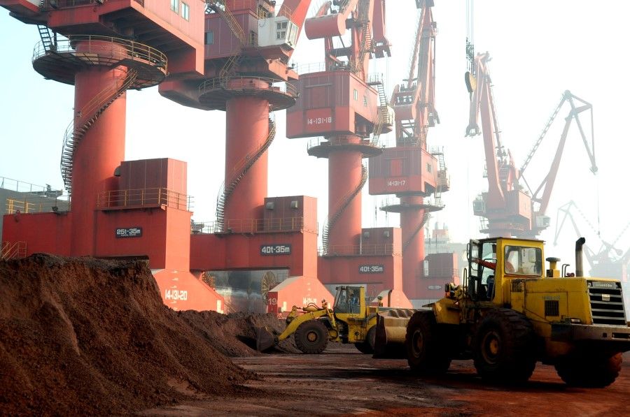Workers transport soil containing rare earth elements for export at a port in Lianyungang, Jiangsu province, China, 31 October 2010. (Stringer/Reuters)