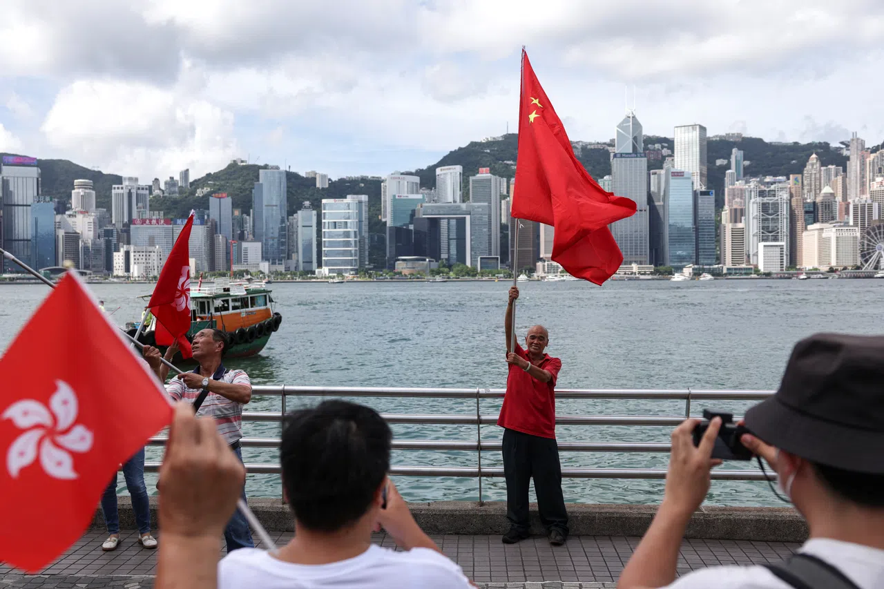 People hold Chinese and Hong Kong flags celebrating the 29th anniversary of the former British colony's handover to Chinese rule, in Hong Kong, China, on 1 July 2026.