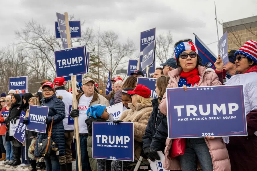 Trump supporters wait together ahead of Republican presidential candidate and former President Donald Trump's visit to the Londonderry High School polling station on 23 January 2024 in Londonderry, New Hampshire. (Brandon Bell/AFP)
