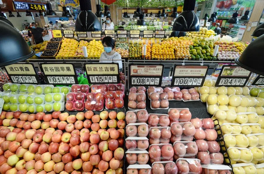 A customer buys vegetables at a supermarket in Handan in China's northern Hebei province on 10 August 2020. (STR/AFP)