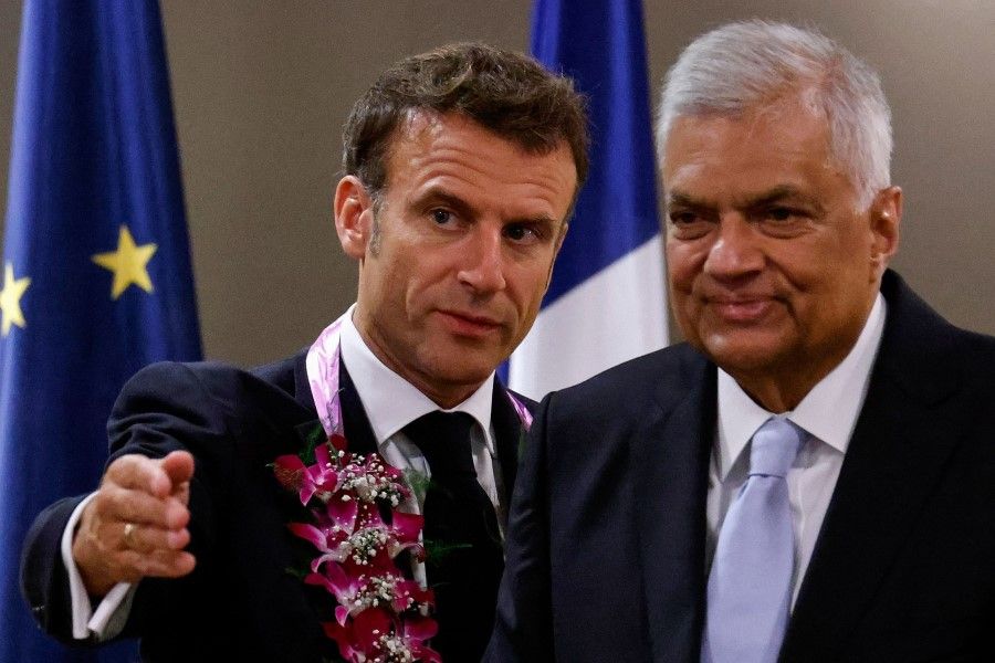 France's President Emmanuel Macron (left) talks to Sri Lanka's President Ranil Wickremesinghe (right) before bilateral talks in Colombo on 28 July 2023. (Ludovic Marin/AFP)