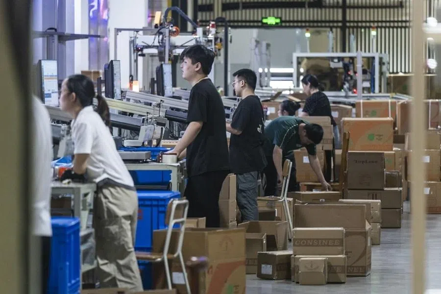 Workers pack products into boxes at yarn manufacturer Consinee Group's plant in Ningbo, China, on Wednesday, June 3, 2026. China installed more than half of the world’s new industrial robots in recent years, according to the International Federation of Robotics, as Chinese manufacturers automated inspection, assembly and logistics. Photographer: Qilai Shen/Bloomberg