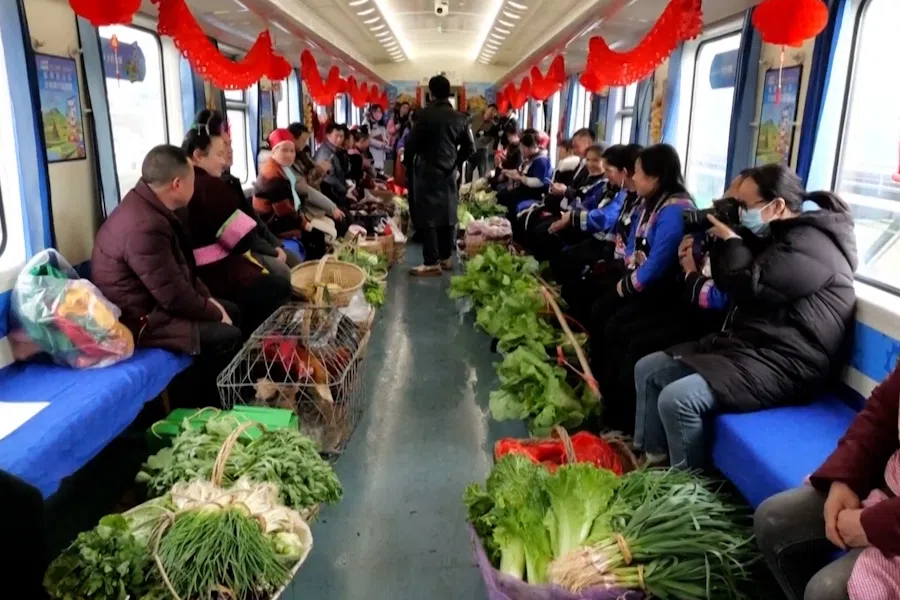 Villagers sell agricultural products on train, Guizhou province, China, on 25-27 January 2024. (Screen grab from CCTV)