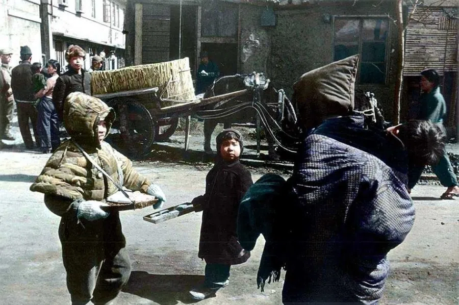 Japanese women and children selling cigarettes on the streets of Shenyang, Manchuria, in the early spring of 1946.