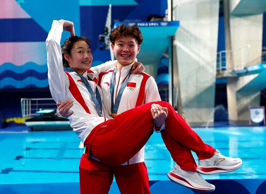 Gold medallists Chang Yani and Chen Yiwen of China celebrate winning the women’s synchronised 3m springboard event, Aquatics Centre, Saint-Denis, France, on 27 July 2024. (Gonzalo Fuentes/Reuters)