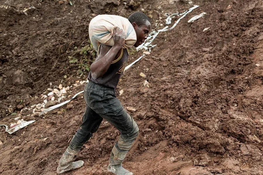 A labourer carries a sack of ore at the Rubaya coltan mine, in the town of Rubaya, which is controlled by M23 rebels, in the eastern Democratic Republic of the Congo, on 24 March 2025.
