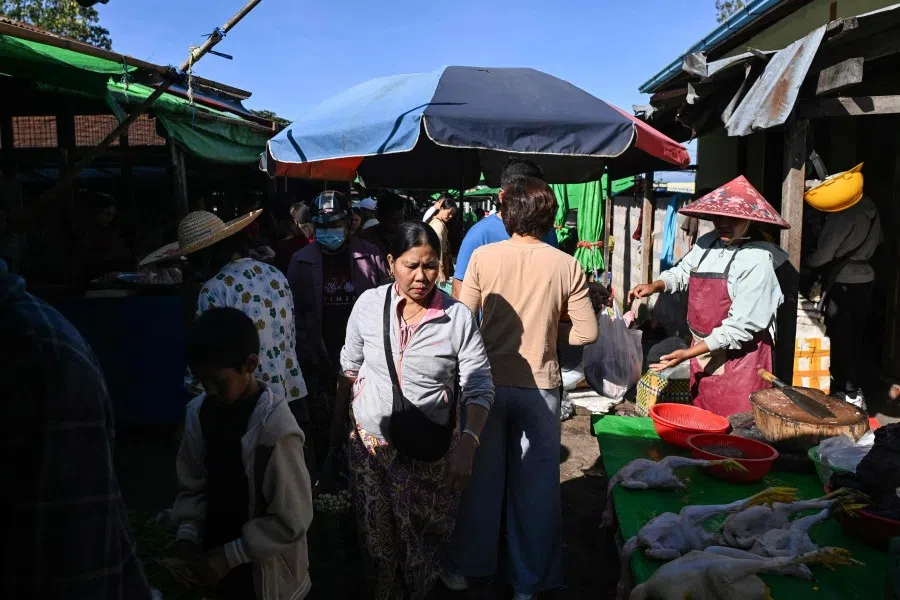 People walk through a market in Taunggyi in Myanmar’s northeastern Shan State on 31 October 2025. (Sai Aung Main/AFP)