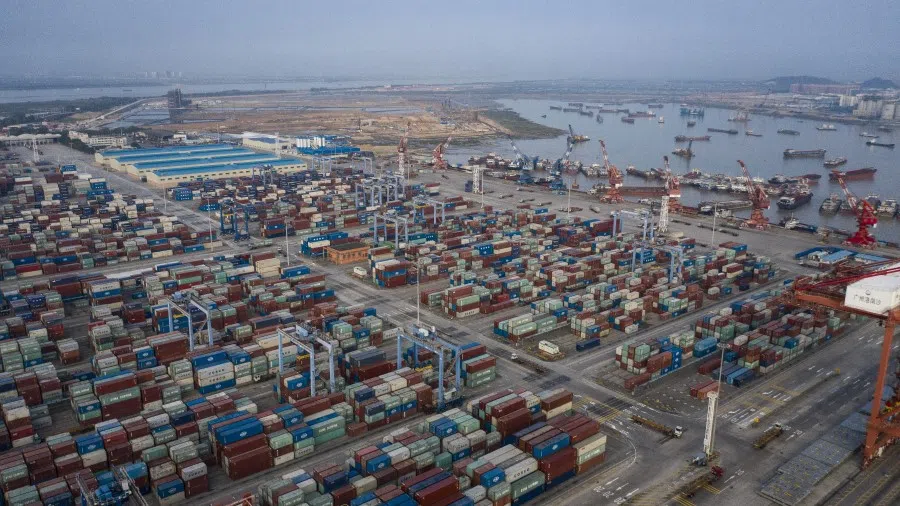 Shipping containers are stacked at the Port of Nansha, operated by Guangzhou Port Group Co., in the Nansha district of Guangzhou, China, on 20 November 2020. China's ability to keep selling more of its goods abroad means officials will be in no rush to rein in their strongest yuan in more than two years. (Qilai Shen/Bloomberg)