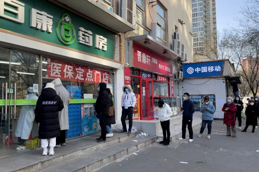 People line up at a fever clinic of The Central Hospital of Wuhan, after the government gradually loosened coronavirus disease (Covid-19) restrictions, in Wuhan, Hubei province, China, 9 December 2022. (Martin Pollard/Reuters)