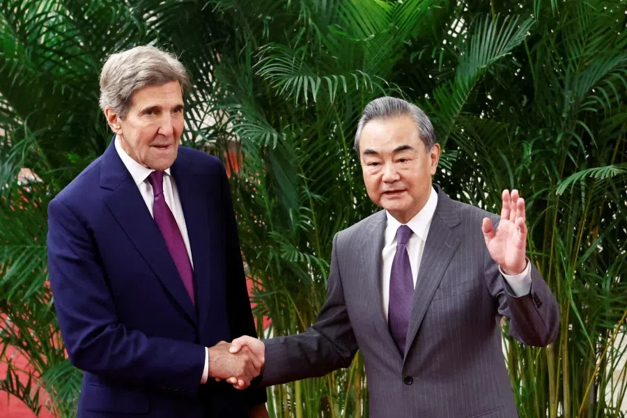 US Special Presidential Envoy for Climate John Kerry and Chinese top diplomat Wang Yi shake hands before a meeting at the Great Hall of the People in Beijing, China, 18 July 2023. (Florence Lo/Reuters)