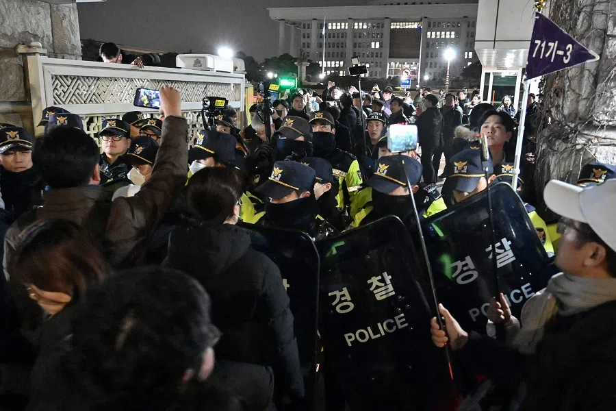 Police stand guard in front of the main gate of the National Assembly in Seoul on 3 December 2024, after South Korea’s president Yoon Suk-yeol declared emergency martial law on the same day. (Jung Yeon-je/AFP)