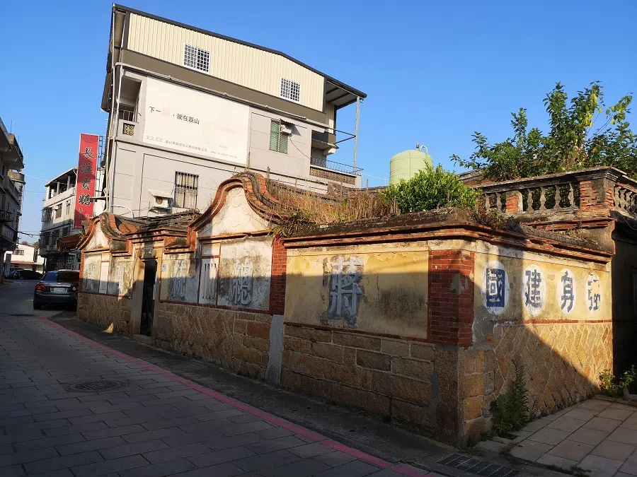 Faded walls bearing slogans from past eras.