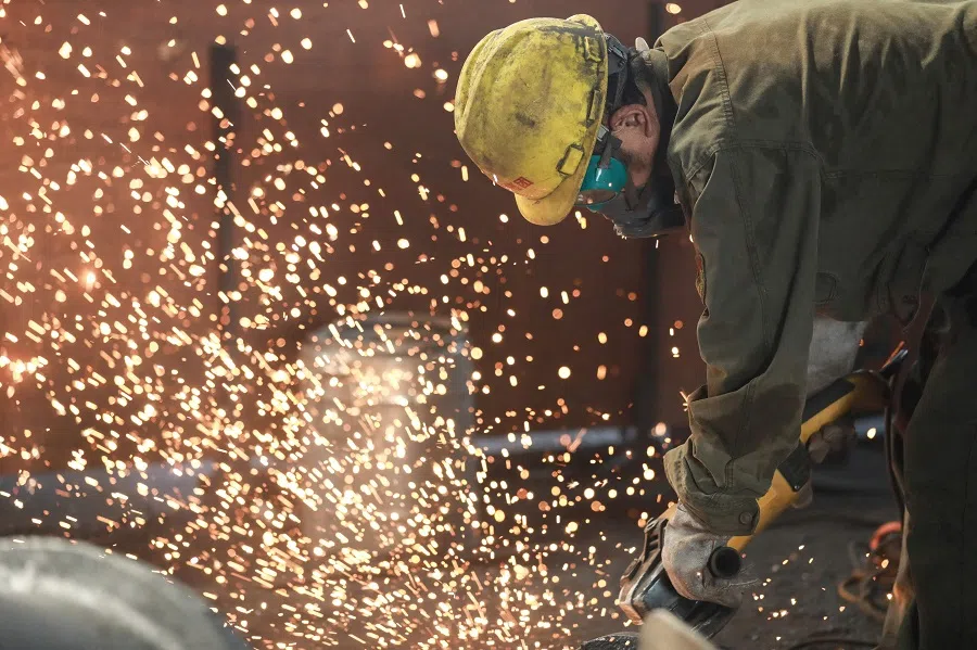 A worker welding metal at a factory in Hangzhou in China's eastern Zhejiang province, on 15 July 2023. (AFP)