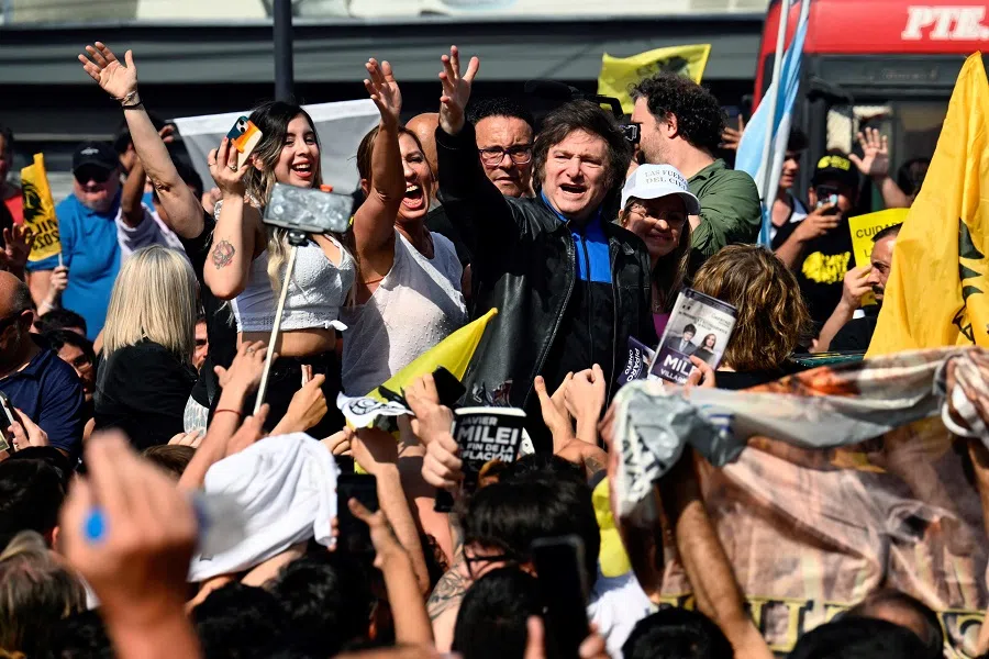 Argentine congressman and presidential candidate for La Libertad Avanza Javier Milei (centre) greets supporters during a campaign rally on 16 October 2023, in Lomas de Zamora, Buenos Aires province, Argentina. (Luis Robayo/AFP)