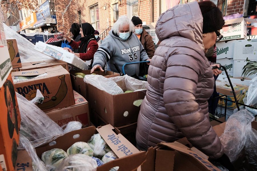 Free food is handed out by the Brooklyn community organisation PASWO during a weekly food distribution on 8 December 2021 in New York City, US. (Spencer Platt/Getty Images/AFP)