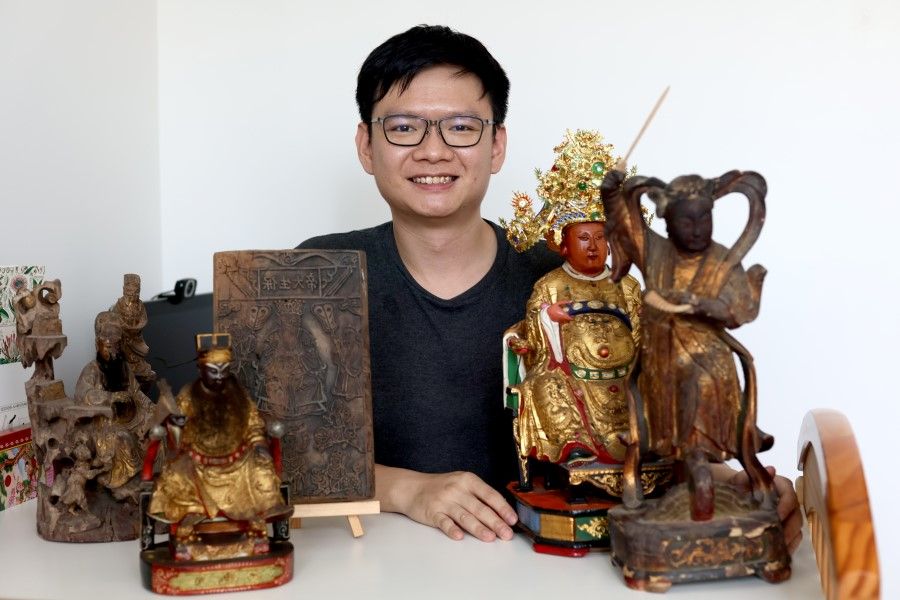 Dean Wang with some of his figurine collection.