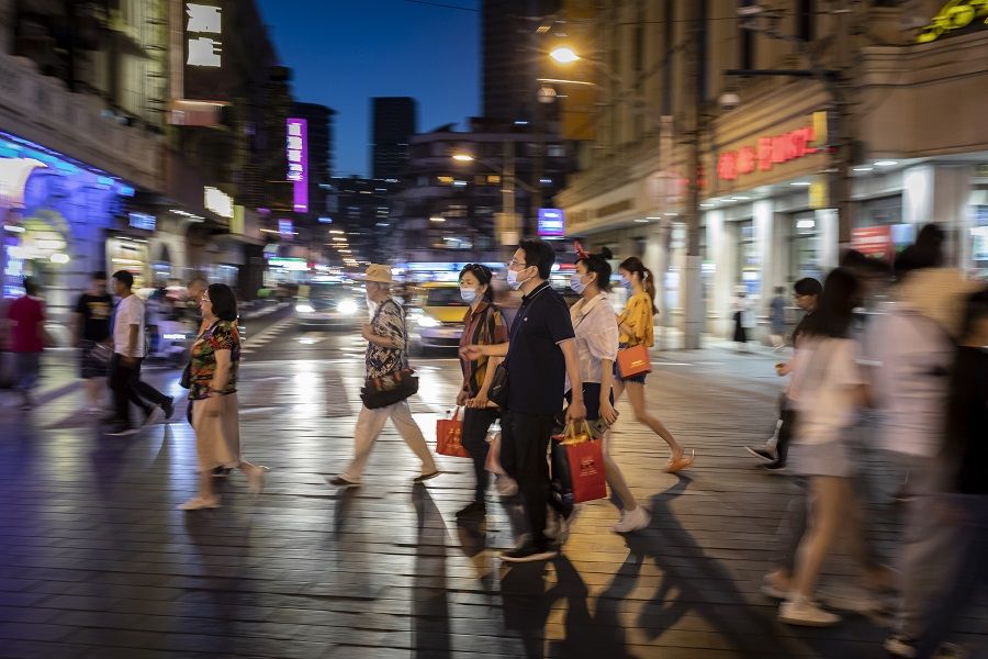 Shoppers and pedestrians walk along Nanjing Road in Shanghai, China, on 6 June 2021. (Qilai Shen/Bloomberg)