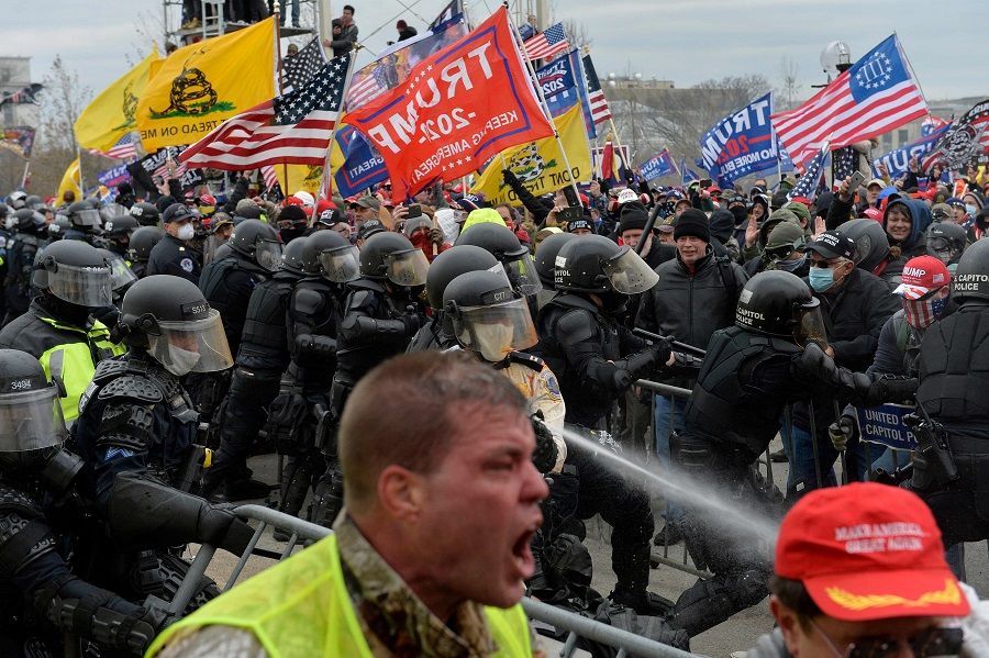 In this file photo taken on 6 January 2021, Trump supporters clash with police and security forces as people try to storm the US Capitol in Washington DC. (Joseph Prezioso/AFP)