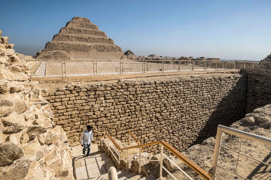 A man walks out of the southern cemetery near the step pyramid of the third dynasty Ancient Egyptian Pharaoh Djoser at the Saqqara Necropolis south of Egypt's capital Cairo on 14 September 2021. (Khaled Desouki/AFP)