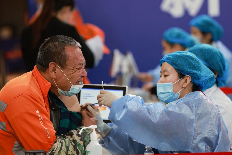 This photo taken on 23 May 2021 shows a sanitation worker receiving the China National Biotec Group (CNBG) Covid-19 vaccine in Shenyang, Liaoning province, China. (STR/AFP)