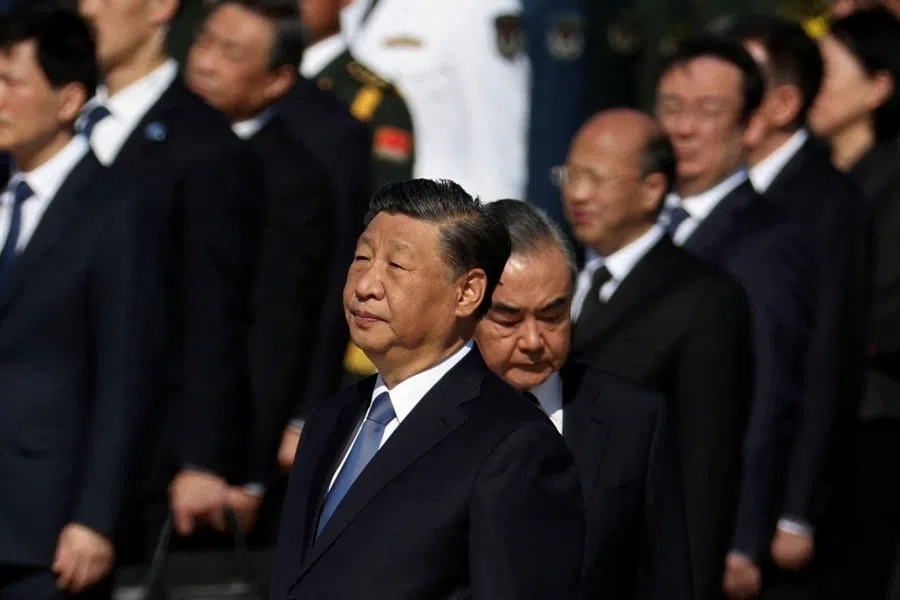 Chinese President Xi Jinping and Foreign Minister Wang Yi attend a ceremony to present flowers at the Monument to the People's Heroes to commemorate Martyrs' Day, a day ahead of China's National Day, on Tiananmen Square in Beijing, China, 30 September 2023. (Florence Lo/Reuters)