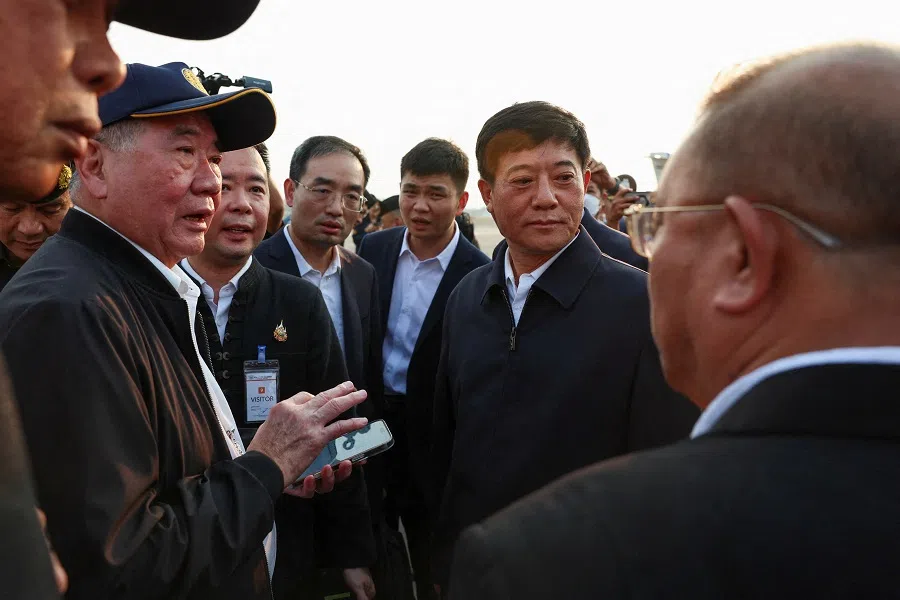 Thailand’s Deputy Prime Minister Phumtham Wechayachai (left, with cap and phone) and Chinese Assistant Minister of Public Security Liu Zhongyi (centre right) speak as they inspect the repatriation of Chinese nationals who were taken from scam centers in Myanmar amid a mounting crackdown on scam centres operating along a porous border, at Mae Sot International Airport, in Mae Sot District, Tak province, Thailand, on 20 February 2025. (Chalinee Thirasupa/Reuters)