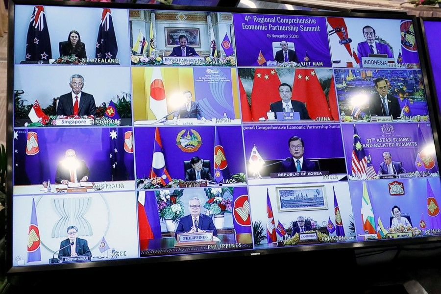 ASEAN leaders are seen on a screen as they attend the 4th Regional Comprehensive Economic Partnership Summit as part of the 37th ASEAN Summit in Hanoi, Vietnam, 15 November 2020. (Kham/REUTERS)