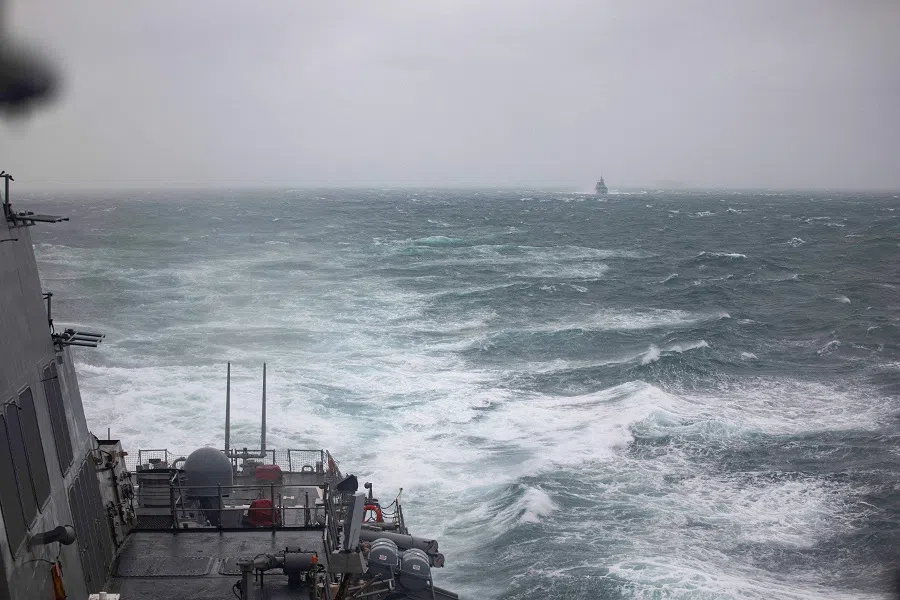 This handout photo taken on 20 October 2024 and released on 21 October by the US Navy shows the Arleigh Burke-class guided-missile destroyer USS Higgins (DDG-76), foreground, and Royal Canadian Navy Halifax-class frigate HMCS Vancouver (FFH 331), in background, sailing in the Taiwan Strait. (Trevor Hale/US Navy/AFP)