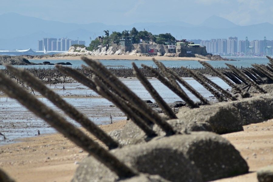 A Taiwanese military outpost on Shihyu islet is seen past anti-landing spikes placed along the coast of Lieyu islet on Taiwan's Kinmen islands, which lie just 3.2 kms (two miles) from the mainland China coast, on 10 August 2022. (Sam Yeh/AFP)