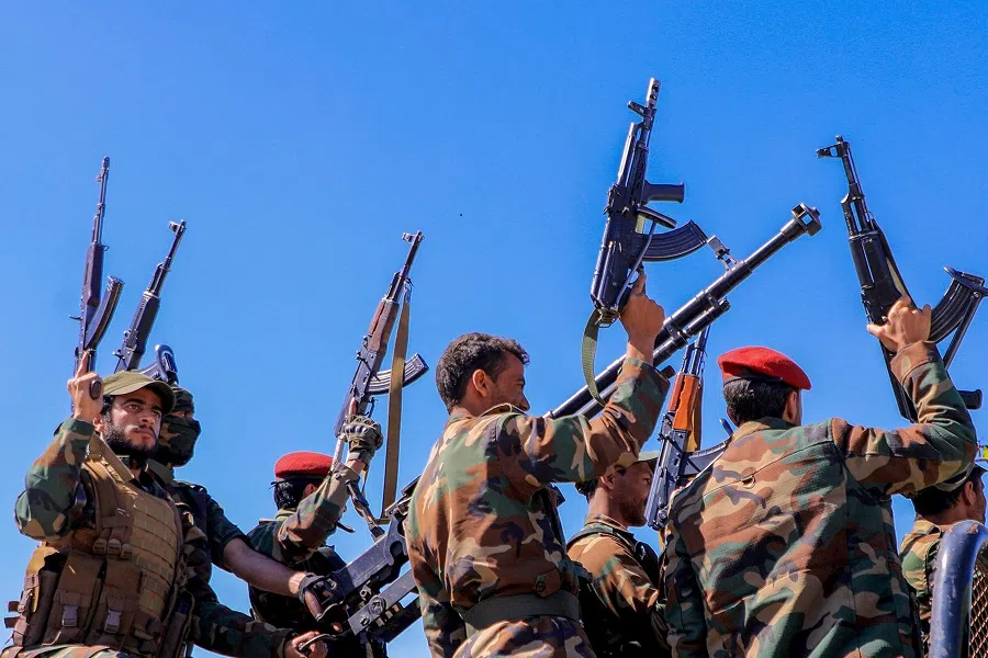 Houthi fighters brandish their weapons as they rally during an anti-Israel and anti-US rally in the Houthi-controlled capital Sanaa, Yemen, on 22 January 2024, amid ongoing battles between Israel and Hamas. (Mohammed Huwais/AFP)
