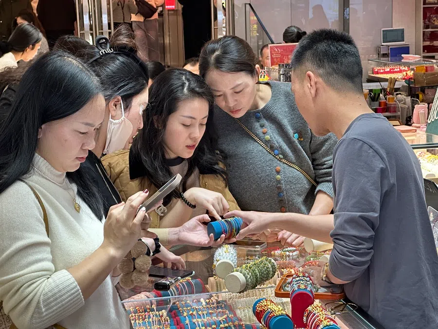 A group of women shopping for crystals at a crystal store.