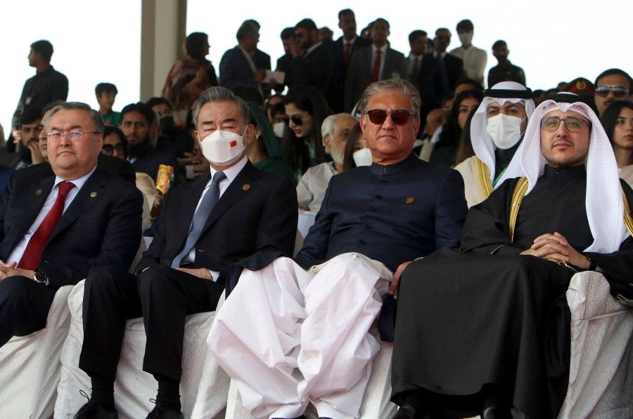China's Foreign Minister Wang Yi (second from left) and Kazakhstan Foreign Minister Mukhtar Tileuberdi (left) sit with Pakistan's Foreign Minister Shah Mahmood Qureshi (second right) and Kuwait's Foreign Minister Sheikh Ahmad Nasser Al-Mohammad Al-Sabah (right), as they watch the Pakistan Day parade in Islamabad on 23 March 2022. (Ghulam Rasool/AFP)