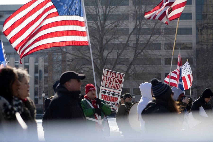 Supporters of former US President Donald Trump gather to demand a forensic audit of the 2020 presidential election in front of the Michigan State Capitol in Lansing, Michigan, US, 8 February 2022. (Emily Elconin/Reuters)