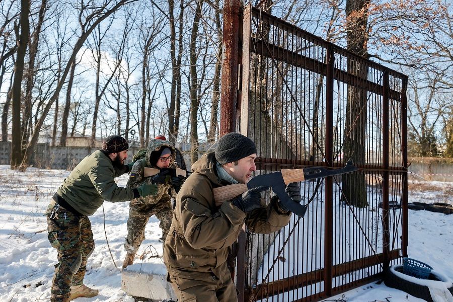 People take part in a military exercise for civilians conducted by members of the Georgian National Legion paramilitary volunteer unit amid the threat of Russian invasion in Kyiv, Ukraine, 4 February 2022. (Serhii Nuzhnenko/Reuters)